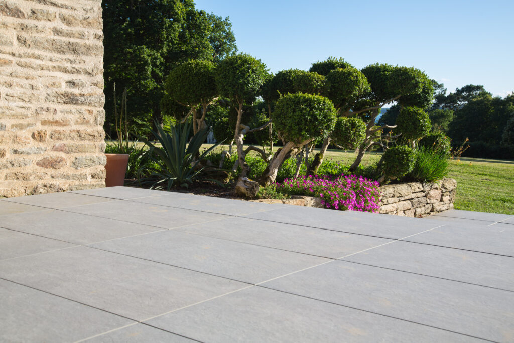 Une terrasse en carrelage gris.